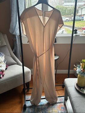 Blush Jumpsuit with Tie Waist and elastic ankle.